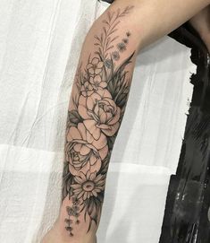 a woman's arm with flowers on it