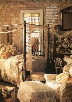 an old fashioned bedroom with stone walls and furniture