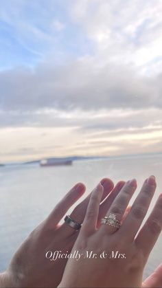 two people holding their hands up to the sky with one person's hand in front of them