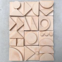 an art work made out of wood with geometric shapes and circles on the top half