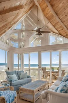 a living room filled with furniture next to the ocean