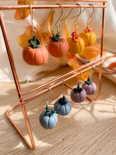 four pumpkins hanging from a rack on a table