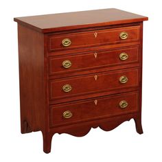 an antique chest of drawers with brass pulls and knobs on the top, against a white background