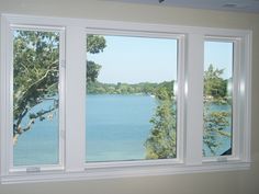 there are three windows that look out over the water in this room, and one is empty