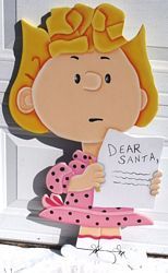 a paper cutout of a girl holding a sign that says dear santa on it