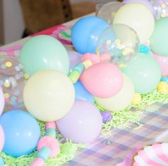 there are many balloons and streamers on the table