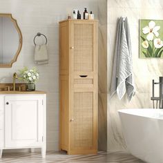 a white bath tub sitting next to a wooden cabinet