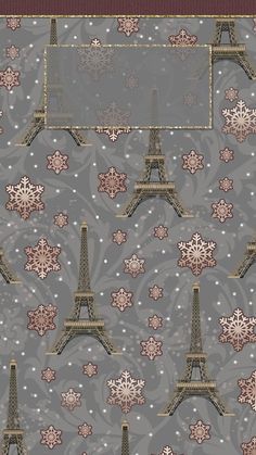 the eiffel tower is surrounded by snowflakes and other decorative objects on a gray background