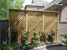 a wooden fence with flowers growing on it