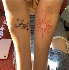 two people with tattoos on their legs and one has a sun and the other is a moon