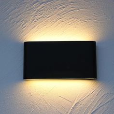 a wall mounted light on the side of a building