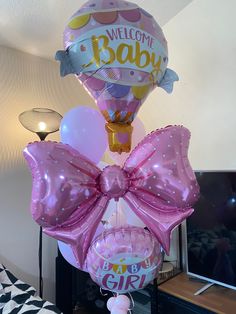 a bunch of balloons that are in the shape of a baby's first birthday