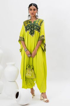 Green long kaftan kurta with hand embroidered ajrakh patch yoke in front. Comes with pant.
Components: 2
Pattern: Embroidered
Type Of Work: Ajrakh, Sequin, Zari, Thread
Neckline: Notched
Sleeve Type: Batwing
Fabric: Satin
Color: Green
Other Details: 
Note: Potli bag held by the model is not for sale
Occasion: Mehendi and Haldi - Aza Fashions Traditional Designer Kaftan With Mirror Work, Traditional Festive Kaftan With Mirror Work, Traditional Drape Kaftan With Mirror Work For Festivals, Traditional Drape Kaftan For Diwali Festival, Festival Zari Work Straight Kurta Kaftan, Bollywood Style Tunic Kaftan With Mirror Work, Bollywood Style Mirror Work Kaftan Tunic, Bollywood Style Kaftan With Mirror Work For Navratri, Festival Kaftan With Mirror Work