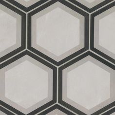 an abstract hexagonal pattern made up of black and white tiles on a wall