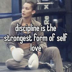 a woman sitting on the ground with her arms crossed and texting, discipline is the strongest form of self love