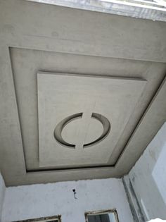 a ceiling with a circular light fixture in the center