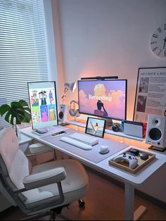 a white desk topped with two computer monitors and a laptop sitting on top of it