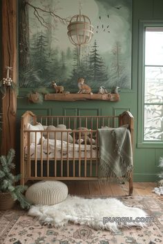 a baby's room decorated in green and white with deers on the wall