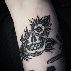 a black and white photo of a skull with flowers on it's head