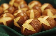 star shaped bread rolls in a basket on a green tablecloth with gold stars painted on them