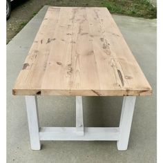 a wooden table sitting on top of a cement floor