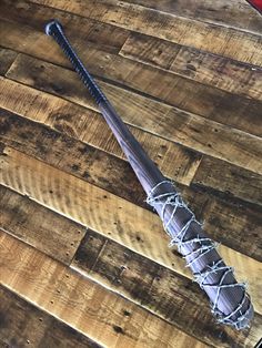 a baseball bat laying on top of a wooden floor