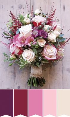 a bouquet of flowers sitting on top of a wooden table next to a wall with wood planks