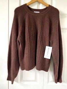 ATHLETA BROWN LAYOVER SWEATER WOMEN'S SIZE 1X NEW WITH TAGS! Soft knit, Merino Wool blend sweater in a rich brown hue, I believe it's alled Mahogany. Tagged a size 1X, it measures 23" across chest at underarms, 24" long from top of shoulder to hem, and 35" from center back neck to end of sleeve.  Description from website: FOR: Layering up to and from your workout FEEL: Soft waffle yarn feels cozy on the skin FAVE: Rib cuffs and collar provide extra comfort #882538 Merino Wool/Nylon/Spandex ALL-A Brown Knit Sweatshirt For Winter, Winter Brown Knit Sweatshirt, Brown Cable Knit Tops For Layering, Cozy Brown Sweater For Fall, Cozy Brown Fall Sweater, Brown Cozy Fit Sweatshirt For Loungewear, Brown Cozy Sweater For Layering, Ribbed Crew Neck Sweater For Fall, Brown Ribbed Collar Top For Fall