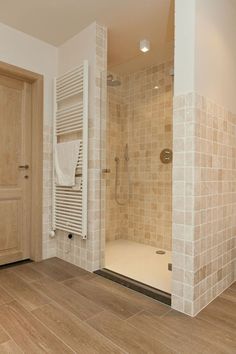 a bathroom with tiled walls and wooden floors