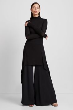 Peak "minimalism with an edge" at your service. Handcrafted from our beloved sheer European jersey, Stef is a relaxed-fit tunic featuring a turtleneck and long sleeves complete with cuffs and thumbhole. Her asymmetric hem gives an added level of flowing sophistication with day to night versatility: layer her over leggings for an effortless athleisure look, or pair her with wide-leg pants for maximum drama. | Sam, in red is 5'8" (173 cm) tall, wearing size XS. Natalee, in anthracite, is 5'10" (17 Long Top With Pants, Dressy Leggings Outfit, Classy Outfits Black, Effortless Athleisure, Tunic Dress With Leggings, Classy Black Outfits, Malaysia Fashion, Classy Tops, 2024 Lookbook