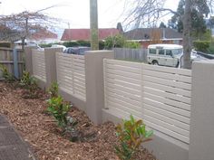 a white van is parked behind a fence