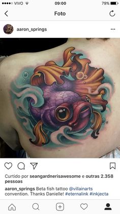 an octopus tattoo on the back of a woman's shoulder