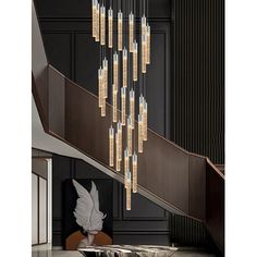 a chandelier hanging from the ceiling in a room with black walls and stairs