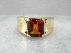 This fantastic ring is straight from the mid-1900's, and though designed for a man, it makes a great cocktail ring for the right lady! We've set this piece with a new, warm and glowing citrine in a bezel of reflective white gold. Handsome and sleek, this autumn hued ring would make a great gift for any occasion. Metal: 14K Yellow Gold and White Gold Gem: Citrine 2.16 Carats Gem Measurements: 7.2 x 8.9 mm, Rectangle Emerald Cut Ring Size: 7 Marks: "<14KT>" Stamped on the inside band Elegant Citrine Signet Ring For Formal Occasions, Timeless Citrine Rings For Formal Occasions, Classic Brown Signet Ring For Anniversary, Elegant Formal Citrine Signet Ring, Brown Polished Finish Signet Ring For Formal Occasions, Formal Brown Signet Ring With Polished Finish, Classic Amber Topaz Ring For Anniversary, Classic Citrine Signet Ring For Anniversary, Classic Citrine Jewelry