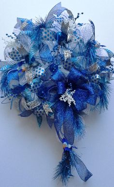 a blue and silver corsage with snowflakes on it