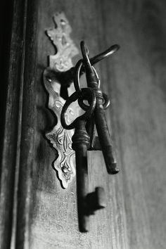 an old door handle with two keys attached to it