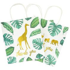 two paper bags with giraffes and palm leaves on them, one has the words thank you