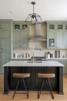 A kitchen with sage green cabinets and a brick backsplash combines earthy tones for a calming, natural look. Sage Cabinets, Sage Green Cabinets, Geometric Light, Cabinets Ideas