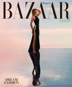 a woman in a black dress on the cover of harper magazine, with her reflection in the water