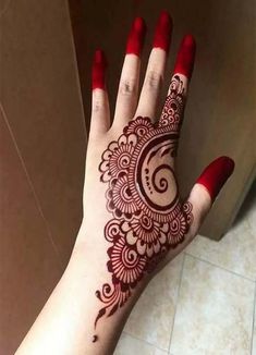 a woman's hand with henna on it