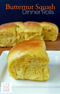 butternut squash dinner rolls on a white plate with the title in the middle above it