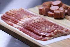 sliced meat on a cutting board next to other food items