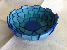 a blue bowl sitting on top of a table