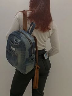 Introducing the perfect combination of style, sustainability, and functionality - our handmade denim backpack. Made with recycled jeans and a 100% cotton lining, this backpack is not only fashionable but also environmentally friendly. With 5 pockets on the outside and 2 deep pockets on the inside, you'll have plenty of space to organize your belongings. The strong webbing straps ensure durability, while the label and genuine leather on the zipper puller add a touch of elegance. Measuring approximately 30 cm in height, 25 cm in width, and 12 cm at the bottom, this backpack is the perfect size for your daily adventures. Inside, the cotton lining is motley, adding a unique and playful touch. Upgrade your backpack game with this one-of-a-kind denim backpackbackpack. Denim Travel Backpack With Pockets, Travel Backpack With Pockets In Denim, Denim Blue Backpack With Pockets For Everyday Use, Denim Backpack With Pockets For Everyday Use, Denim Blue Cotton Backpack For Everyday Use, Denim Standard Backpack With Zipper Closure, Standard Denim Backpack With Pockets, Denim Backpack With Pockets, Denim Backpack With Zipper Closure