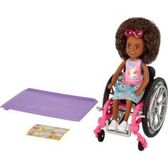 a doll in a wheel chair next to a play mat