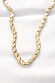 This elegant necklace features a sleek barley grain design, crafted from high-quality steel with a luxurious gold-tone finish. The chain measures 60 cm (23.6 inches), making it a versatile piece that complements both casual and formal outfits. Its smooth, polished surface adds a touch of sophistication to any look. Perfect for those seeking a timeless accessory with a modern edge. Elegant Luxury Necklace With Polished Finish, Luxury Gold-tone Charm Necklace, Luxury Gold-tone Elegant Charm Necklace, Luxury Modern Gold-tone Chain Necklace, Luxury Timeless Gold-tone Necklace, Luxury Gold Necklace With Polished Finish, Luxury Designer Gold-tone Necklaces, Luxury Designer Gold-tone Necklace, Luxury Elegant Custom Necklace With Polished Finish