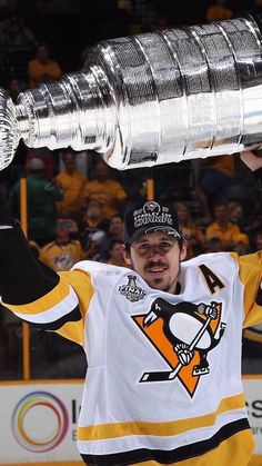 a hockey player holding up the stanley cup