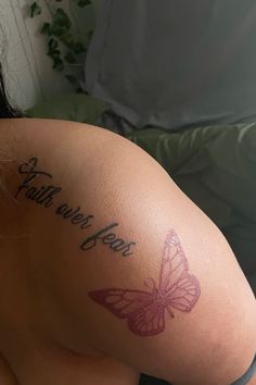 a woman with a butterfly tattoo on her arm that says, faith over fear and the word'faith over fear '