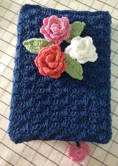 a crocheted square with flowers on it