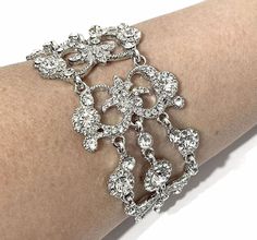 "A Victorian style bridal bracelet with ornate damask curls and motifs, made of clear swarovski crystals, set on tarnish resistant silver rhodium plated base. It has flexible joints. Bracelet crystal is 1 1/2\" (4cm) wide. * Limited edition. While supplies last only. * View matching pieces or similar designs at https://etsy.me/2sewmK9 View all bracelets at https://etsy.me/S9RHlf" Wedding Filigree Adjustable Bracelets, Silver Filigree Bracelets For Wedding, Adjustable Filigree Bracelets For Wedding, Glamorous Silver Bracelets For Wedding, Ornate Bangle Bracelets For Wedding, Old Hollywood Vintage, Hollywood Vintage, Damask Wedding, Vintage Wedding Jewelry